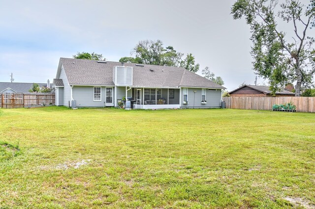 4121 Amberley Trl, Valdosta, GA 31602 - back of property featuring a fenced backyard, a shingled roof, and a sunroom