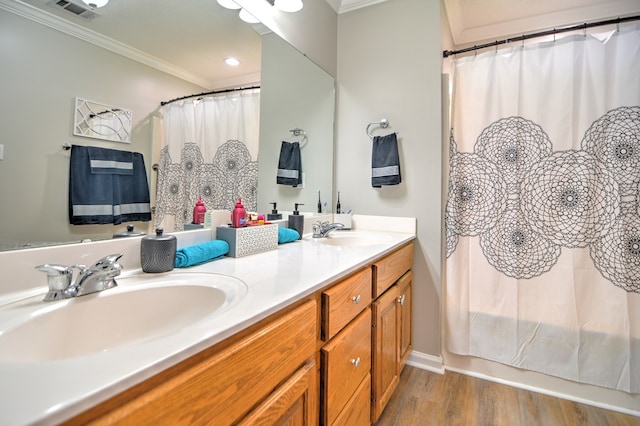 4121 Amberley Trl, Valdosta, GA 31602 - bathroom with ornamental molding, double vanity, and wood finished floors