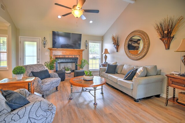 4121 Amberley Trl, Valdosta, GA 31602 - living room featuring lofted ceiling, wood finished floors, ceiling fan, a brick fireplace, and recessed lighting