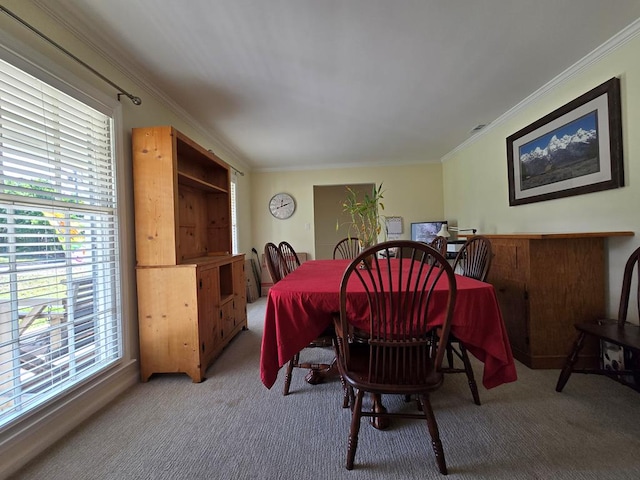 carpeted dining area with ornamental molding