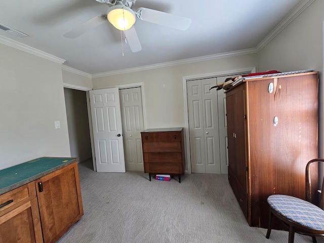 interior space featuring crown molding, visible vents, multiple closets, and light colored carpet