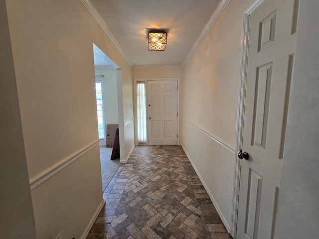 doorway to outside featuring brick floor, baseboards, and ornamental molding