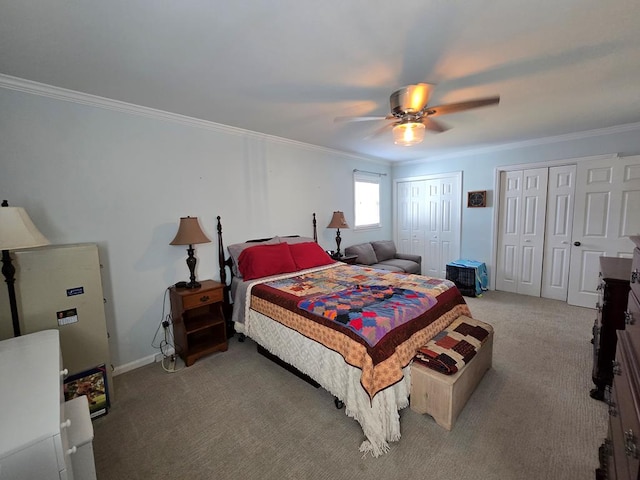 carpeted bedroom with multiple closets, crown molding, baseboards, and ceiling fan