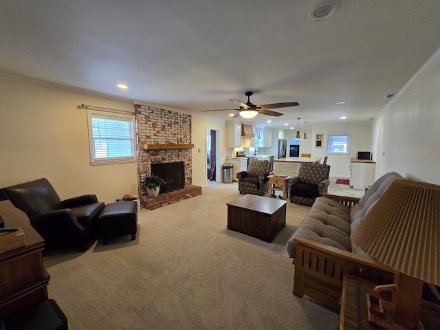 living room featuring recessed lighting, a fireplace, light colored carpet, and crown molding