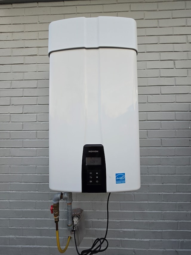 exterior details with water heater and brick siding