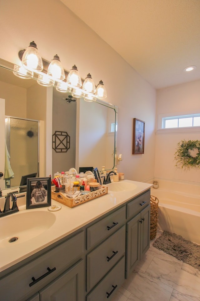5300 Hidden Oaks Blvd, Lake Park, GA 31636 - bathroom featuring double vanity, a bath, a shower stall, marble look tiles, and recessed lighting