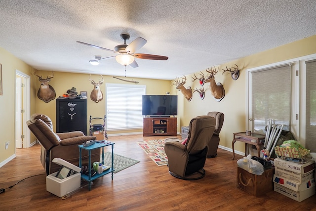 3564 River Chase Dr, Valdosta, GA 31602 - living room featuring a textured ceiling, a ceiling fan, wood finished floors, and baseboards