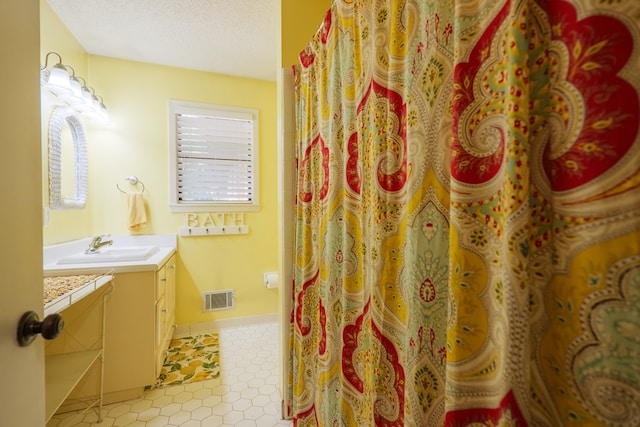 3564 River Chase Dr, Valdosta, GA 31602 - full bath with vanity, a textured ceiling, a shower with curtain, and baseboards