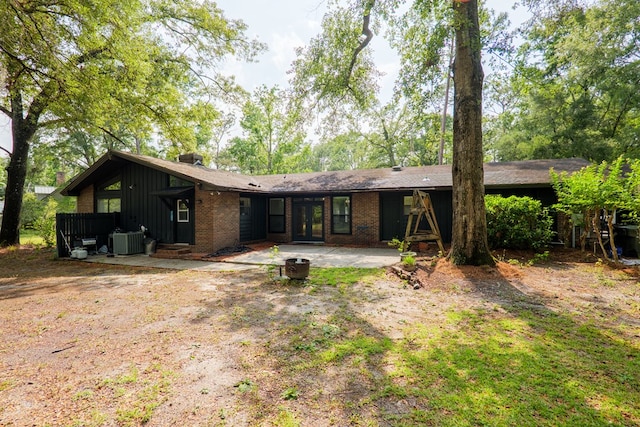 3564 River Chase Dr, Valdosta, GA 31602 - back of house featuring french doors, a patio area, cooling unit, board and batten siding, and brick siding