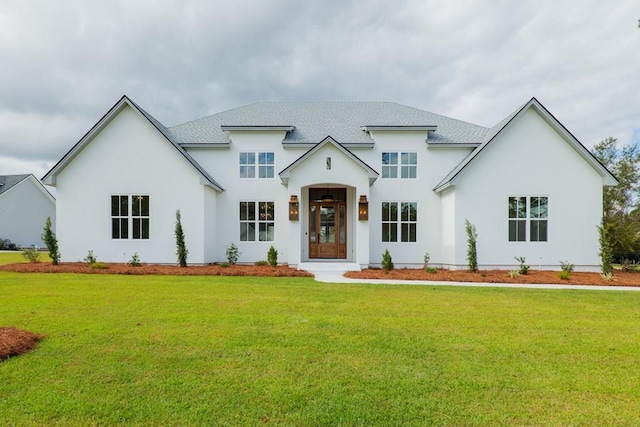 view of front of property featuring a front lawn and stucco siding