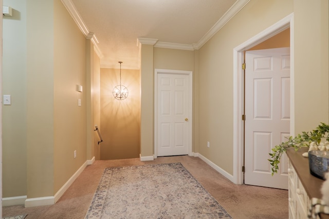 hall featuring light colored carpet, ornamental molding, a textured ceiling, and a chandelier