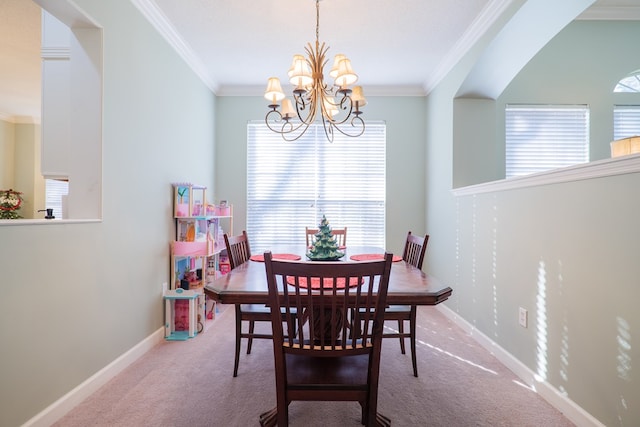 carpeted dining area with ornamental molding and an inviting chandelier