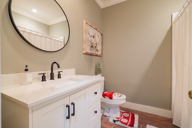 bathroom with crown molding, vanity, and toilet