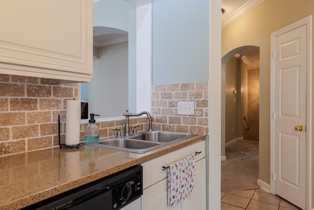 kitchen with light stone counters, ornamental molding, sink, white cabinetry, and light tile patterned flooring