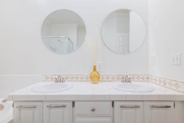 bathroom featuring vanity and a shower with shower door