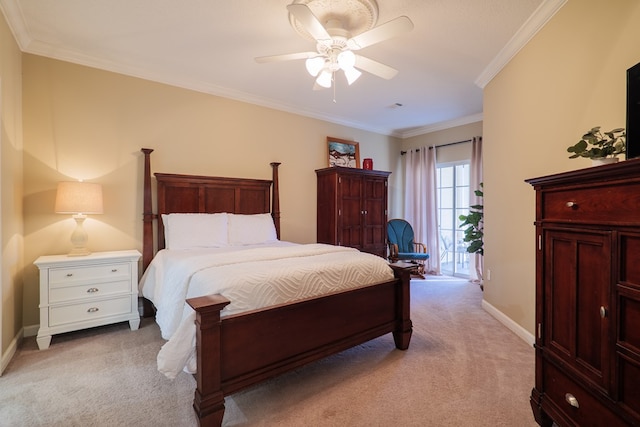 carpeted bedroom with ceiling fan and ornamental molding