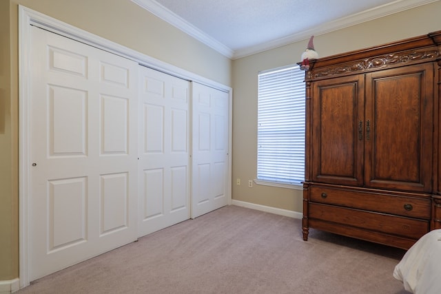 bedroom featuring light carpet, a closet, and crown molding