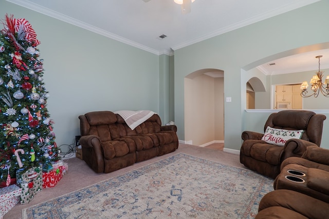 living room featuring light carpet, ceiling fan with notable chandelier, and ornamental molding