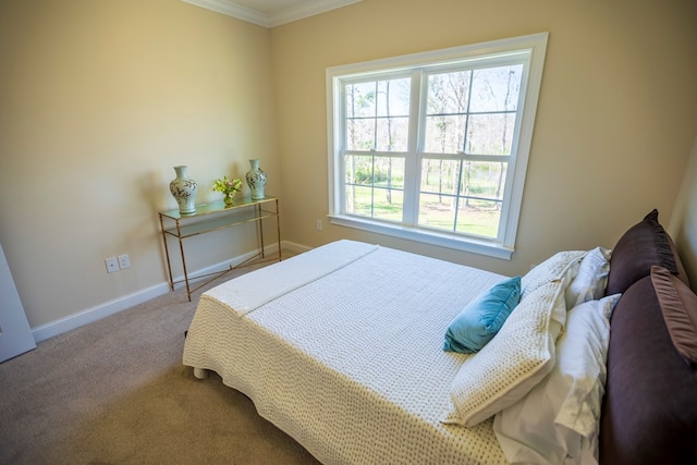 carpeted bedroom featuring baseboards and ornamental molding