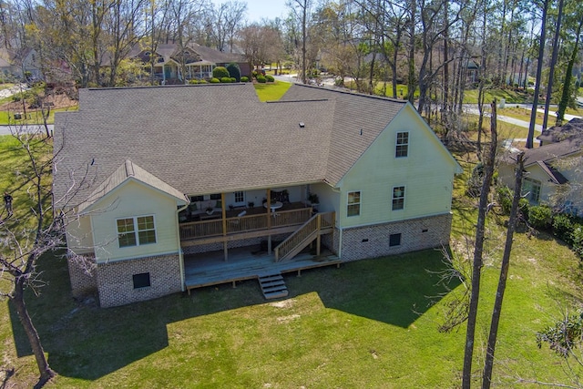 back of property featuring stairs, a lawn, roof with shingles, and a wooden deck