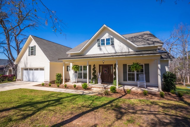 view of front facade with a garage, driveway, a porch, and a front yard