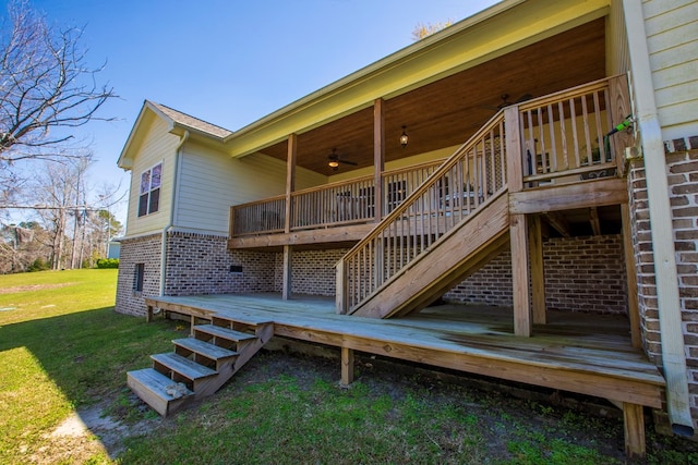 wooden deck with stairs, a yard, and ceiling fan