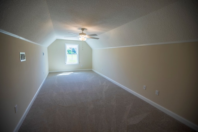 bonus room featuring visible vents, carpet flooring, baseboards, ceiling fan, and vaulted ceiling