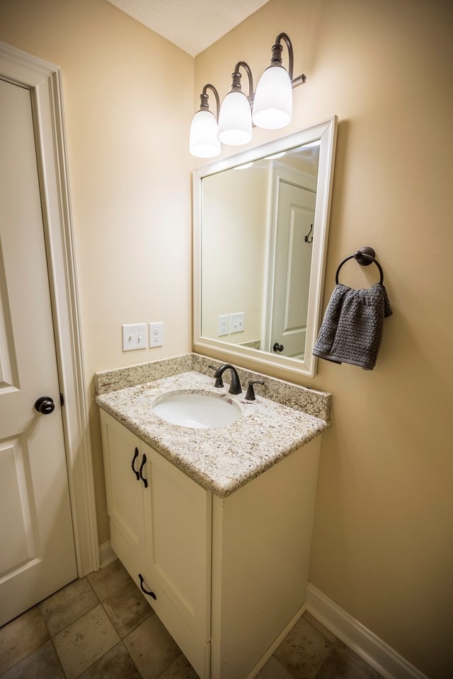 bathroom featuring vanity and baseboards