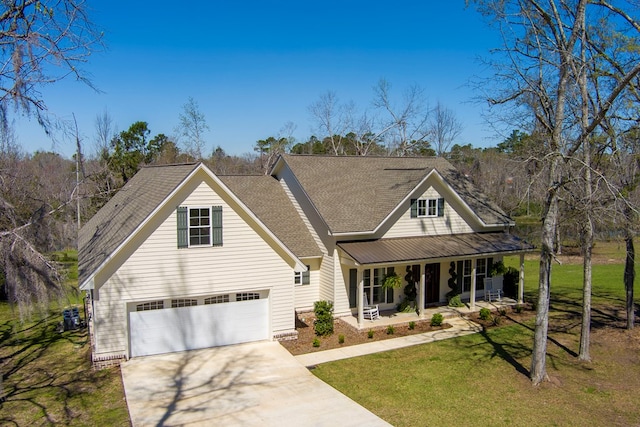 traditional-style home with a porch, concrete driveway, a front lawn, and a shingled roof