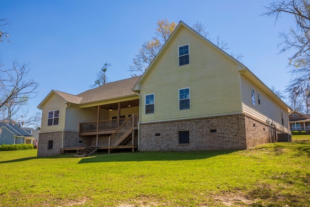 rear view of house with a lawn, stairway, brick siding, central AC unit, and ceiling fan