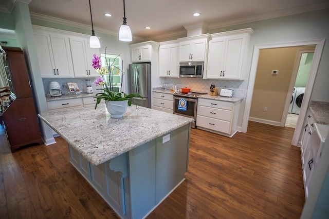 kitchen featuring dark wood finished floors, white cabinetry, stainless steel appliances, and ornamental molding