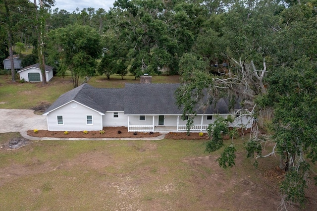 4604 Pinebrook Dr, Lake Park, GA 31636 - view of front of home with covered porch, a chimney, a front lawn, a storage shed, and a shingled roof