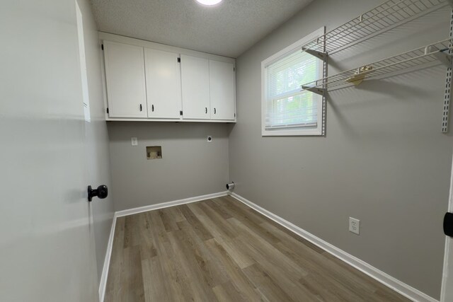 4604 Pinebrook Dr, Lake Park, GA 31636 - laundry area with hookup for an electric dryer, cabinet space, light wood-style flooring, and washer hookup