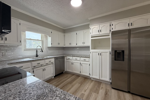 4604 Pinebrook Dr, Lake Park, GA 31636 - kitchen with stainless steel appliances, a textured ceiling, light wood-style floors, crown molding, and white cabinetry
