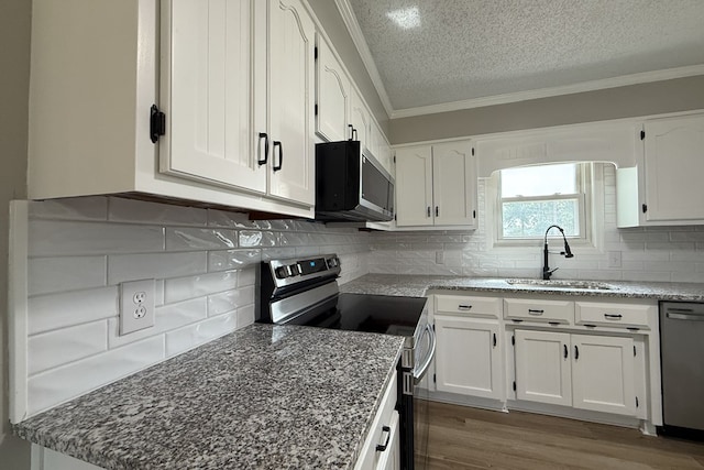 4604 Pinebrook Dr, Lake Park, GA 31636 - kitchen with appliances with stainless steel finishes, a textured ceiling, ornamental molding, white cabinets, and light stone counters