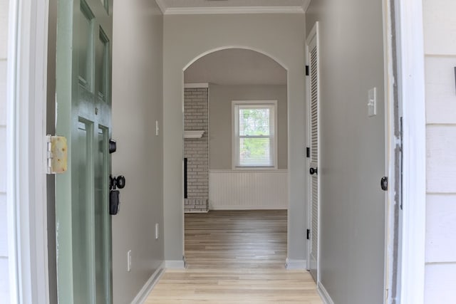 4604 Pinebrook Dr, Lake Park, GA 31636 - hallway featuring arched walkways, light wood finished floors, ornamental molding, and a wainscoted wall