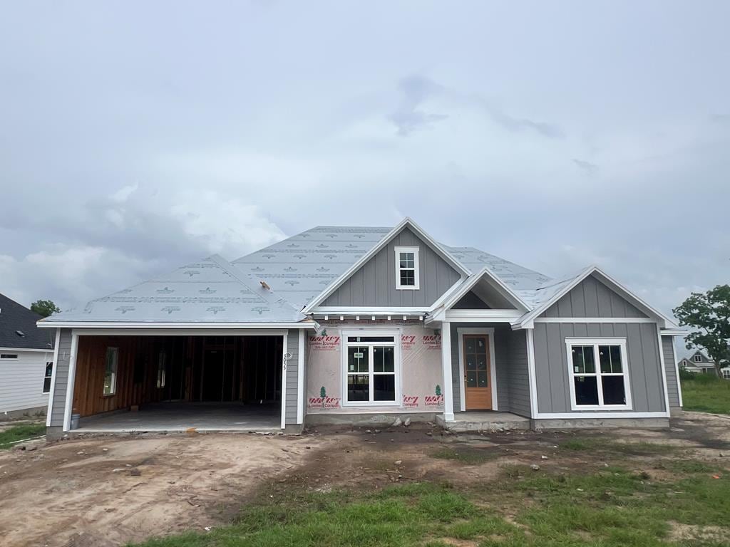 5055 Hatfield Cir, Hahira, GA 31632 - property in mid-construction with an attached garage, board and batten siding, and driveway