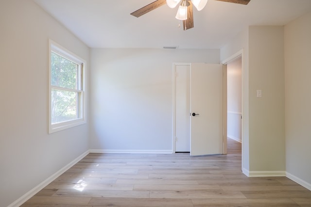 spare room with light hardwood / wood-style floors and ceiling fan