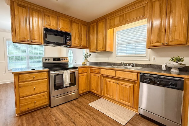 17 Ard Rd, Ray City, GA 31645 - kitchen with stainless steel appliances, a sink, wood finished floors, dark countertops, and brown cabinetry