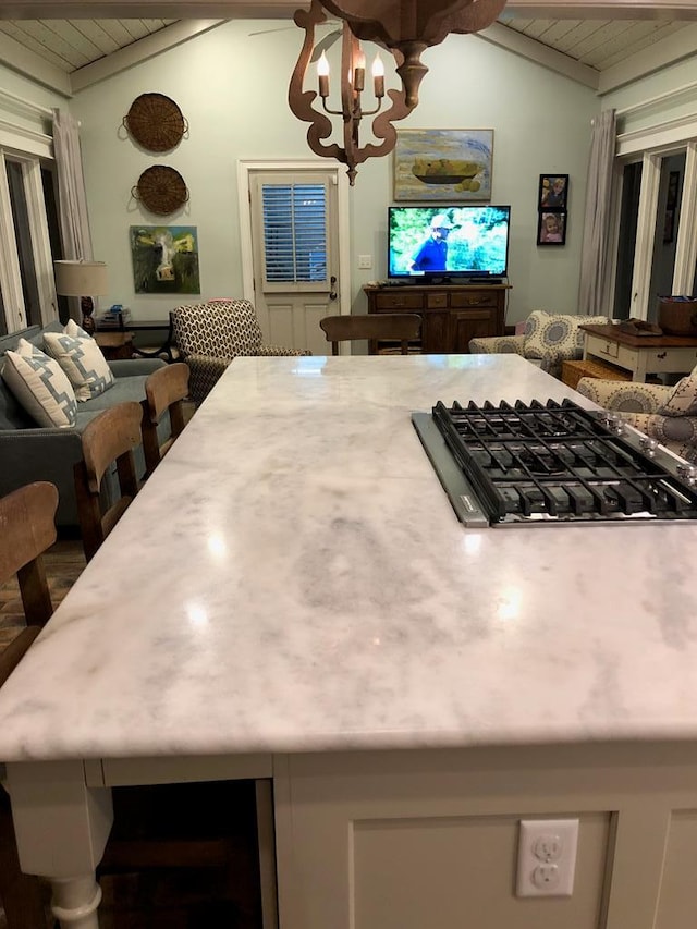 kitchen with stainless steel gas stovetop, a notable chandelier, wood ceiling, and vaulted ceiling