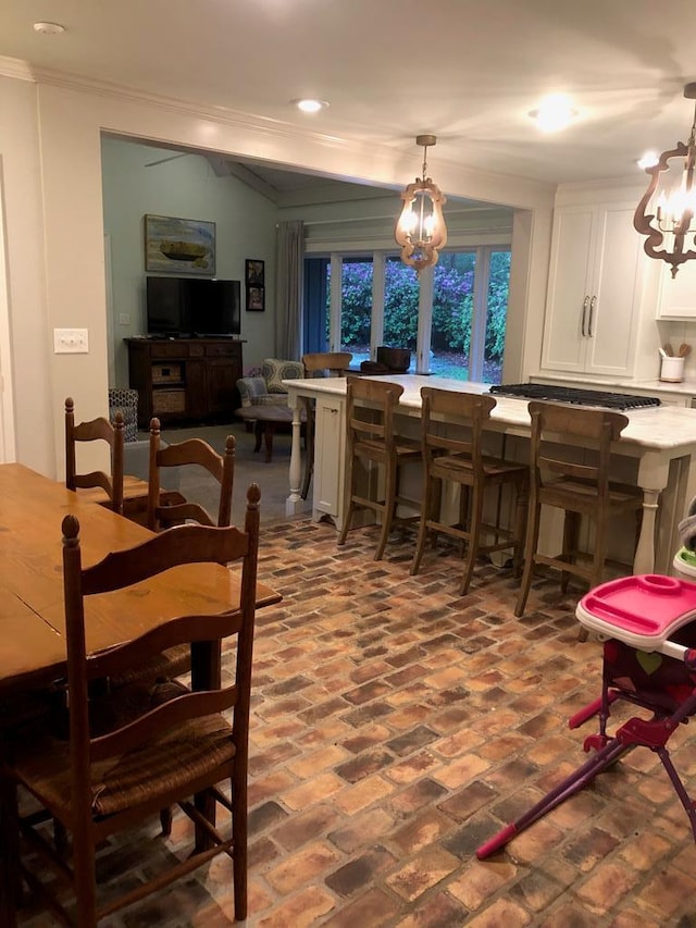 dining space featuring ornamental molding and a notable chandelier