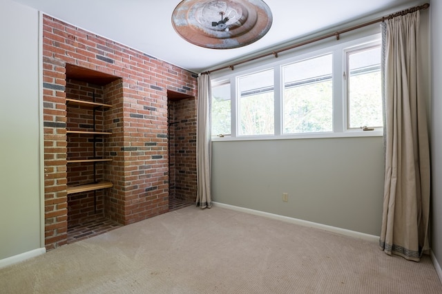 carpeted empty room featuring plenty of natural light