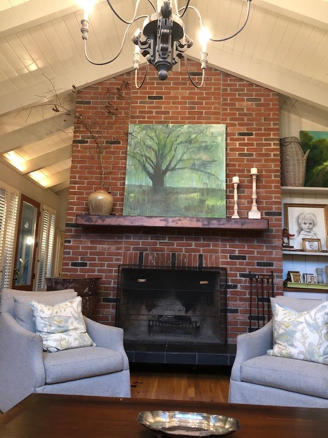 living room with a brick fireplace, hardwood / wood-style flooring, an inviting chandelier, wooden ceiling, and vaulted ceiling with beams