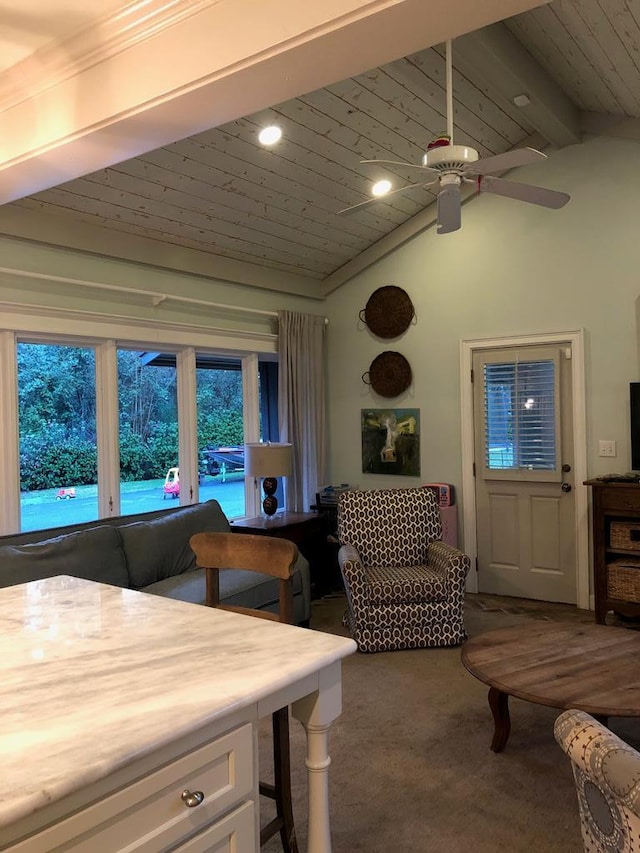 carpeted dining space featuring lofted ceiling with beams, ceiling fan, and wood ceiling