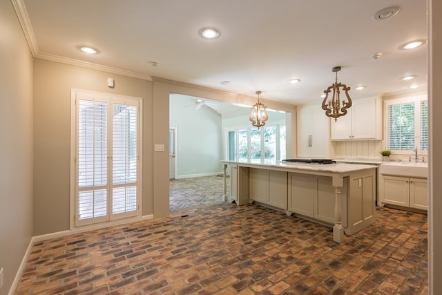 kitchen with pendant lighting, a center island, plenty of natural light, and sink