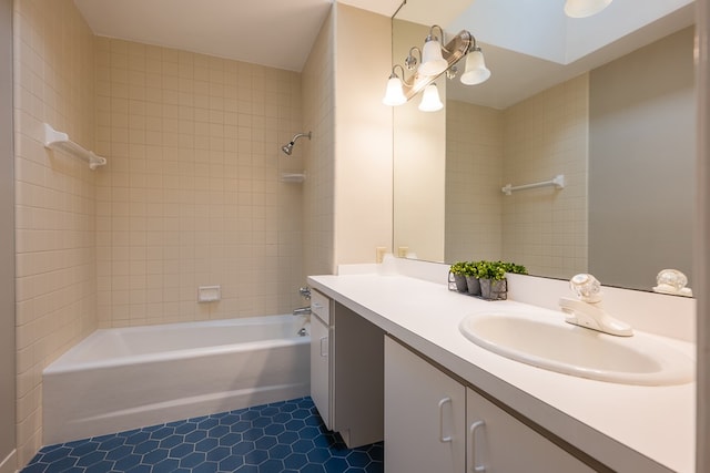 bathroom with tile patterned flooring, vanity, and tiled shower / bath combo