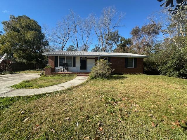 single story home with a porch and a front yard