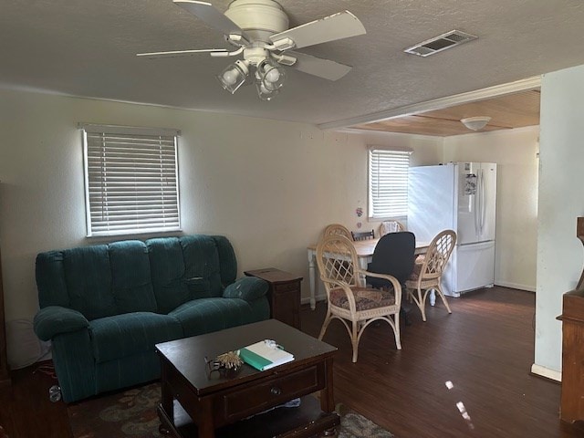 living room featuring a textured ceiling, ceiling fan, and dark hardwood / wood-style floors