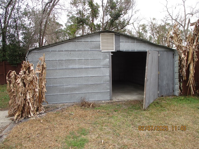 view of outdoor structure featuring a lawn