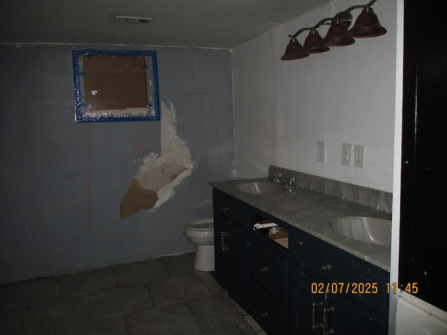 bathroom with vanity, tile patterned floors, and toilet